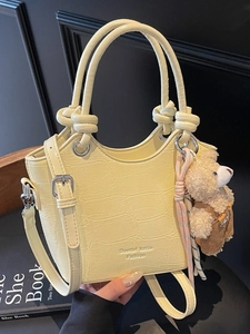 Chic cream yellow crocodile pattern bucket bag with double handles and a cute bear charm