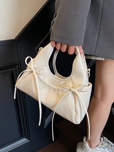 Chic cream white patent leather crescent handbag with bow details for women
