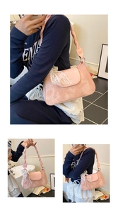 Pink underarm bag detail featuring lace bow and woven handle with marble pattern texture