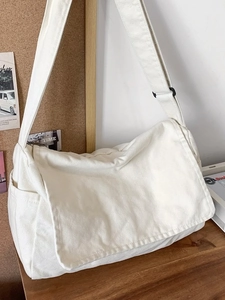 Large capacity off-white canvas messenger bag with adjustable strap in minimalist style