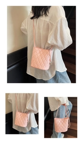 Sac seau matelassé rose avec motif à losanges et détails de breloque boule en métal