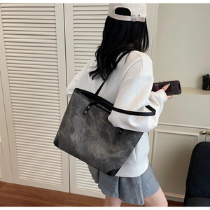 Detail of large tote bag with black marble texture and reinforced leather corner guards