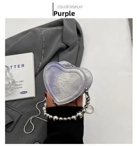 Detailed view of a purple marble heart-shaped crossbody bag with silver bead handle