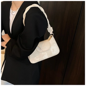Close-up of white marble pattern underarm bag with thick braided shoulder strap detail