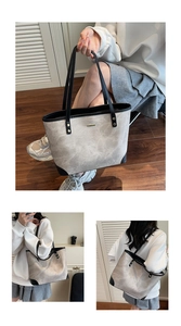 Detail of grey marble pattern tote bag with black trim and gold metal nameplate