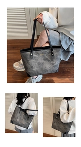 Detail view of large tote bag with grey marble texture and black shoulder straps