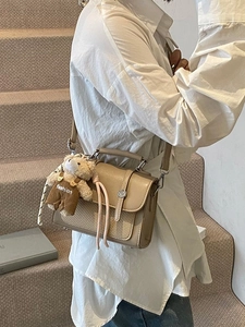 Chic beige crossbody square bag with woven texture and cute teddy bear charm