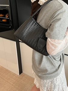 Classic black woven shoulder bag with a rectangular silhouette and Intrecciato craft style