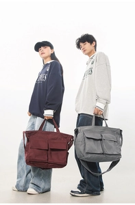 Détail de sacs cabas en toile bordeaux et gris avec poches cargo et bandoulière