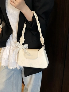 Chic cream white underarm bag with woven strap and lace bow accent for women