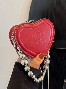 Chic red heart-shaped mini crossbody bag with embossed logo and chunky silver bead chain