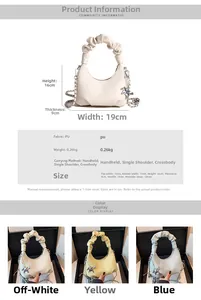 Detail of pleated handle and metal pony charm on a lychee textured crescent handbag
