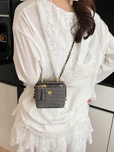 Quilted tweed mini box bag with gold camellia clasp and chain strap on model