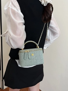 Mint green woven vanity case bag with gold handle and camellia detail for women