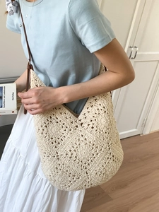 Cream crochet woven shoulder bag with floral hollow patterns and brown leather strap