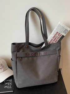 Large dark grey canvas tote bag with side pockets and front zipper for daily work