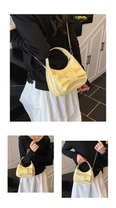 Detail of light yellow bow-tie hobo bag with silver chain strap for shoulder and crossbody use