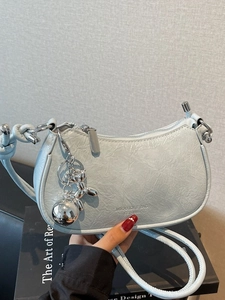 Light blue pleated crescent shoulder bag with silver balloon dog charm detail