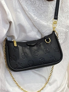 Black pebbled leather baguette bag with cartoon embossing and gold chain shoulder strap