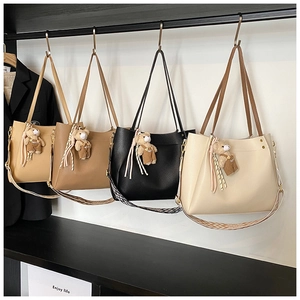 Detailed view of four large capacity tote bags in assorted colors with patterned straps