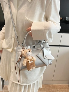 Silver metallic crossbody bag with teddy bear charm and mini pouch in a trendy style