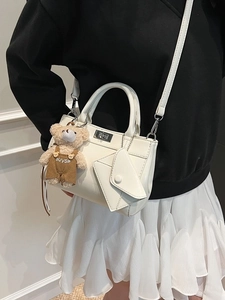 Minimalist beige crossbody bag for women with plush bear charm and small envelope pouch