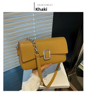 Close-up of khaki retro crossbody bag showing litchi grain texture and metal chain strap