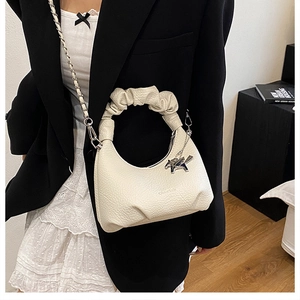 Sac à main croissant en cuir crème avec poignée plissée et détail de breloque cheval