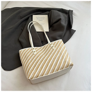 Top view of yellow striped woven tote bag with white leather straps and silver rivets