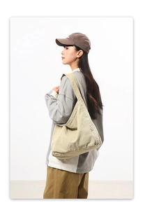 Detailed close-up showing the soft canvas texture and minimal stitching of the tote bag