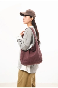 Detailed view of large dark red canvas tote bag showing draped shape and stitching detail