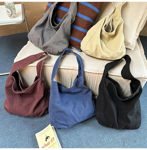 Close-up of high-capacity washed canvas tote bags in multiple colors for daily use