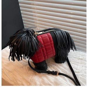 Detail of creative dog-shaped crossbody bag featuring black tassels and red quilted PU leather