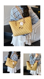 Detail of striped woven tote bag featuring brown leather handles and plush eye charm