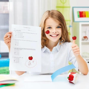Glittery apple reward stickers used on a student paper for teachers and school praise