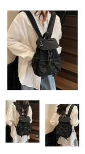 Detail of black nylon drawstring backpack with utility buckles shown on wooden stairs