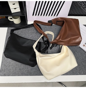 Detailed flat lay of minimalist PU leather tote bags in black, brown, and cream white