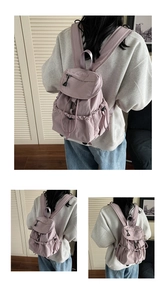 Detail of lilac nylon backpack showing pleated texture and side drawstring closure