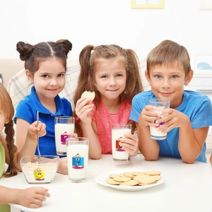 Close-up of glass tableware set with colorful cartoon pencil prints for children dining