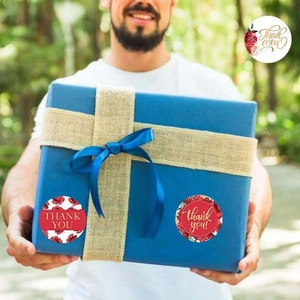 Floral Thank You stickers on a blue gift box with ribbon for decorative packaging