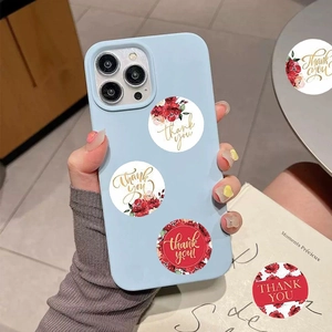 Macro detail of floral Thank You seal stickers on light blue matte smartphone case