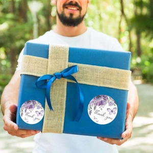 Floral Thank You sticker on blue gift box with purple flowers and butterfly design
