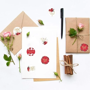 Close-up of floral Thank You stickers with red roses on gift boxes and envelopes