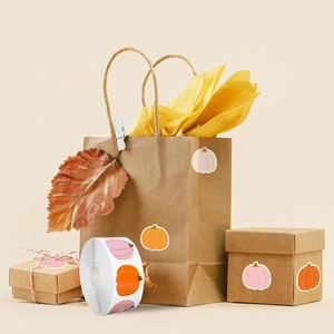 Detail of pumpkin-themed Halloween stickers with gold trim on gift packaging roll