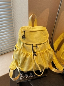 Fashionable bright yellow nylon drawstring backpack with large capacity and flap closure