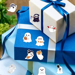 Close-up of Halloween ghost stickers featuring various cartoon characters on a gift box