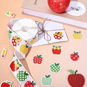 Detail of colorful apple-themed stickers with polka dots and stripes on a roll