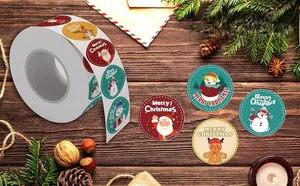 Detail of Christmas seal stickers roll with snowman and Santa on dark wooden background