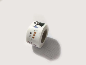Close-up of Halloween stickers roll featuring vampire, reaper and festive cartoon patterns