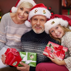 Family scene showing Christmas dog stickers on holiday hats and festive gift boxes